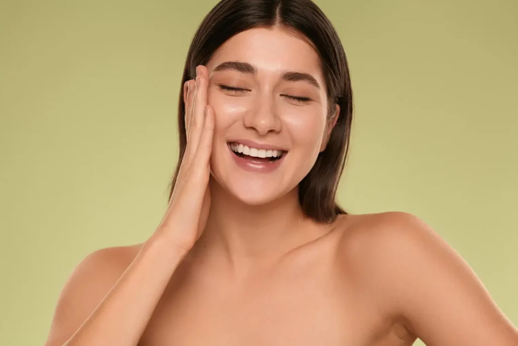 An individual flexing their smooth, firm facial skin.