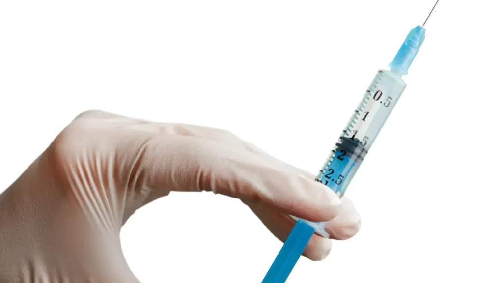 A close-up shot of a medical professional holding an injection.