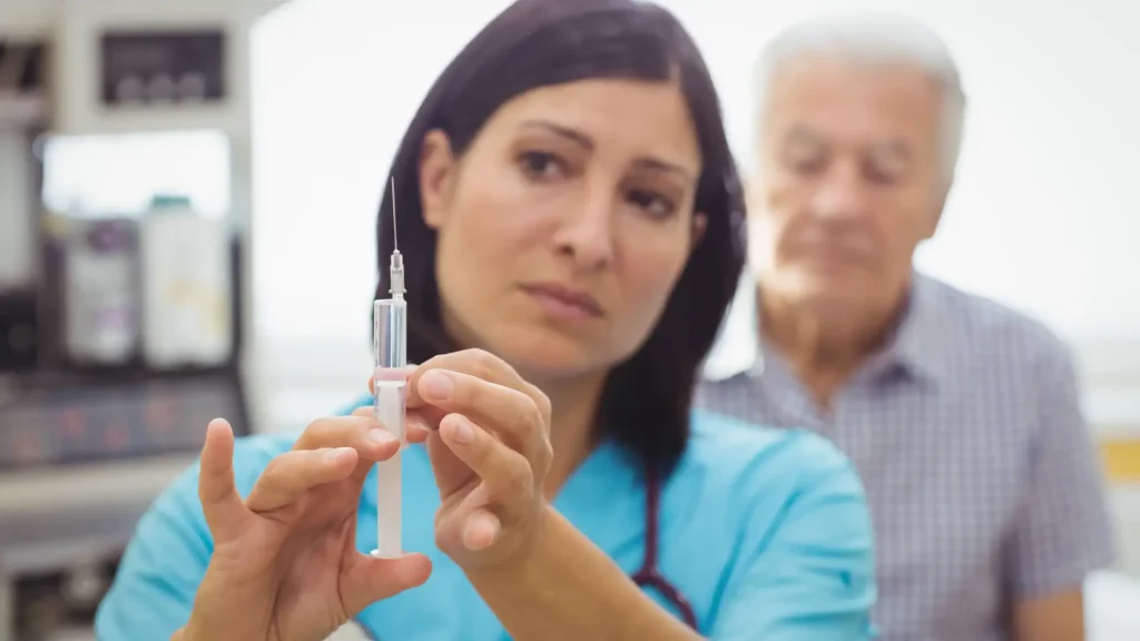 A medical professional preparing the injection for the patient's treatment.