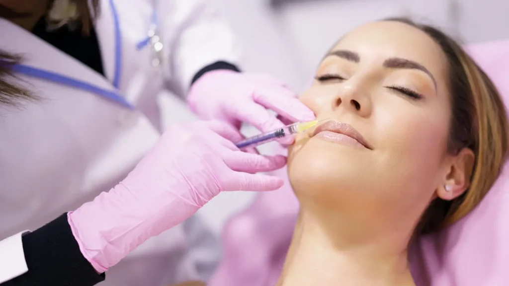 A medical professional administering an injection for their facial injection.