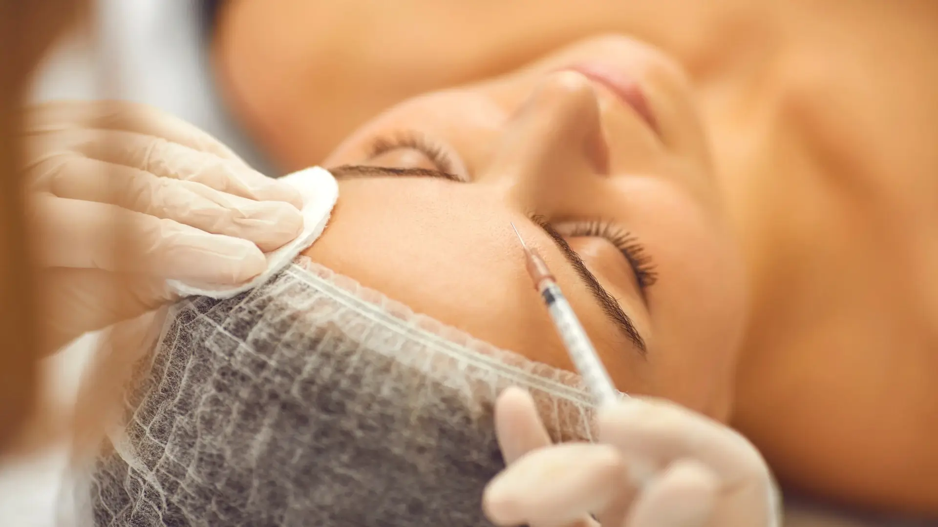 An individual receiving a facial injection into their forehead region.