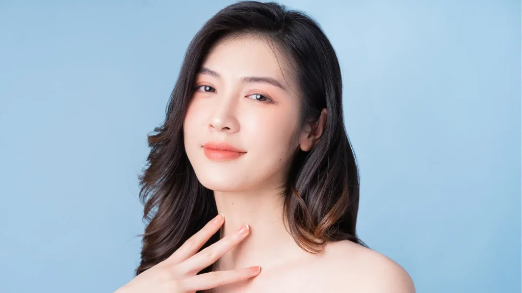 A woman showing off their smooth and clear facial skin.