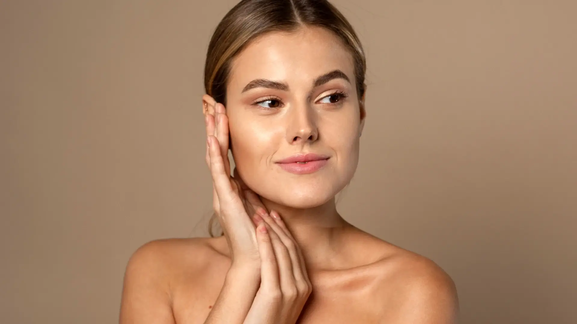 An individual showing off their smooth and clear facial skin.