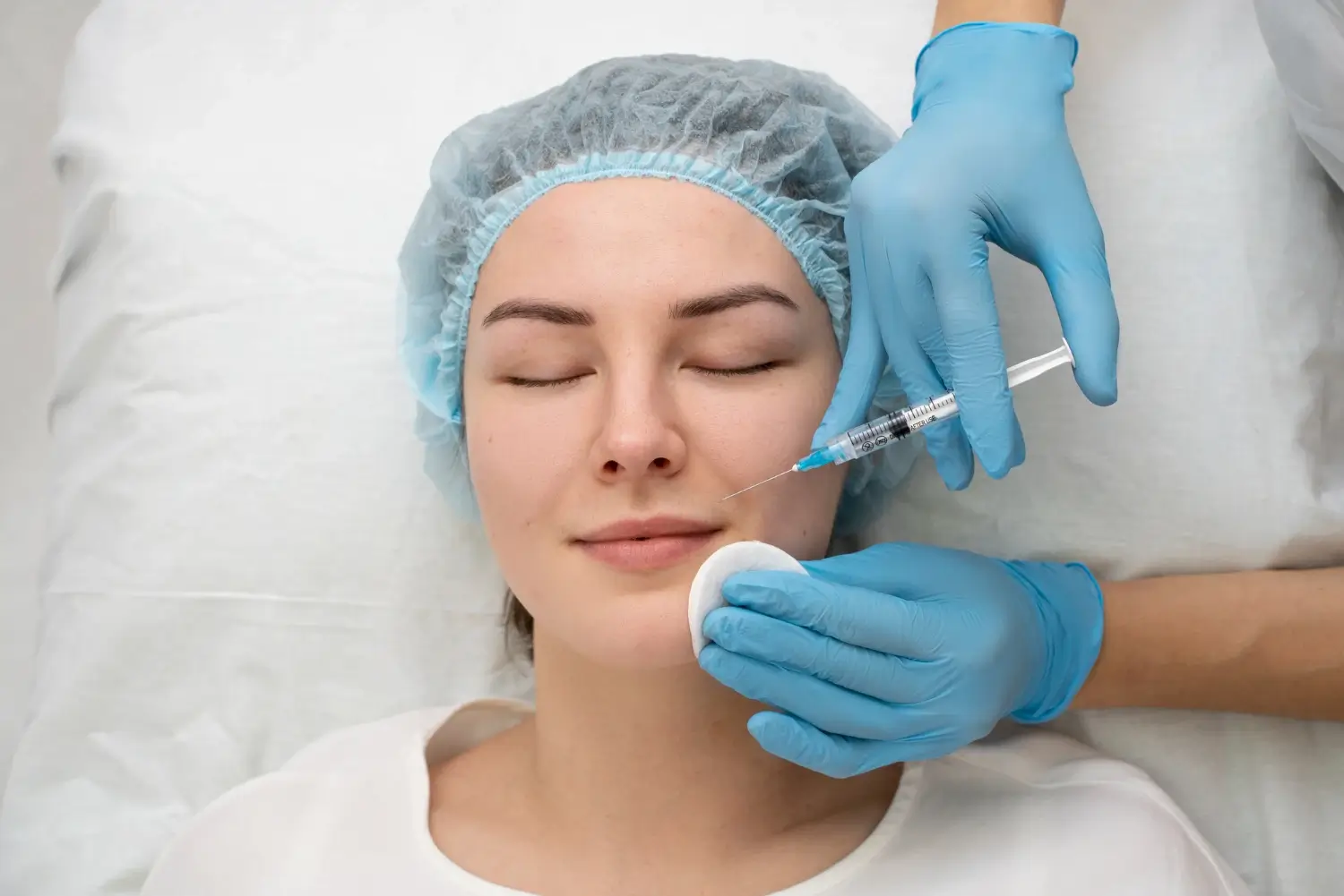 An individual receiving an injection into their nasolabial folds.