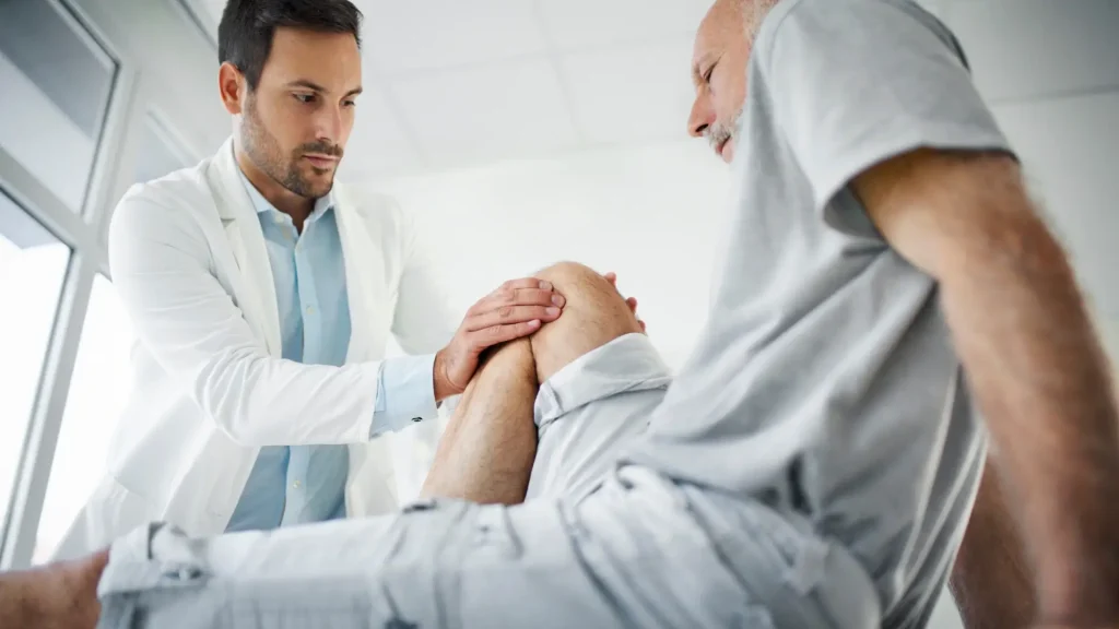 A doctor examining the patient's knee.