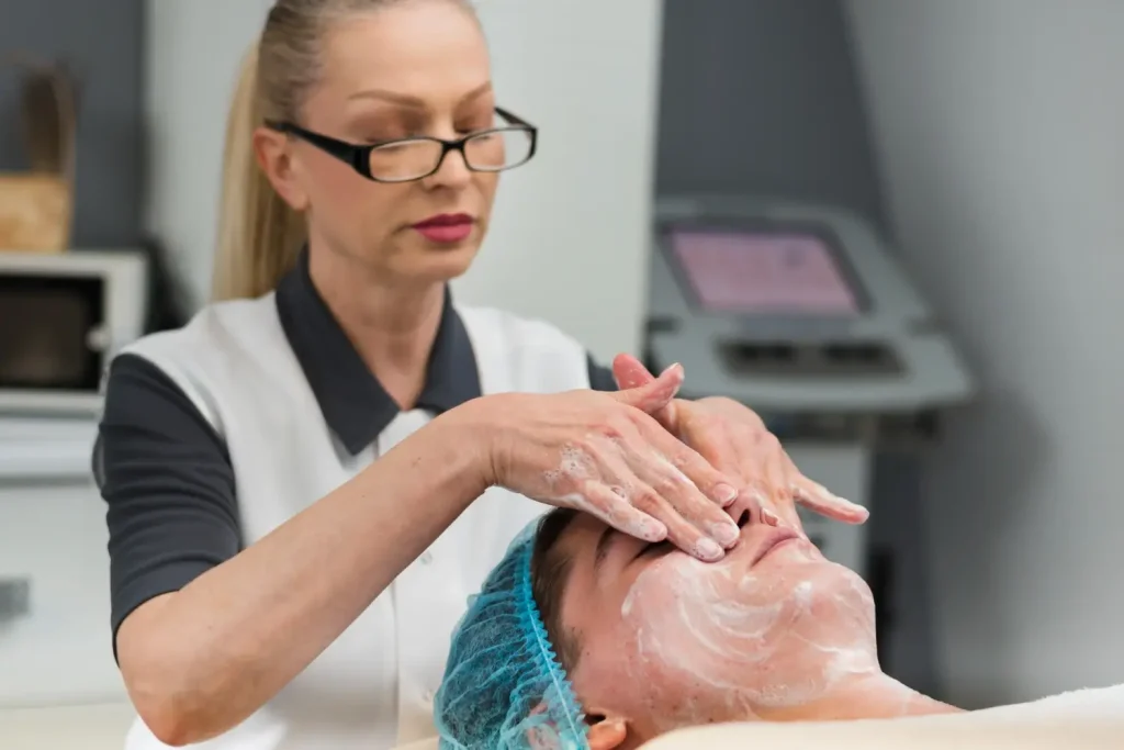 An individual undergoing a facial from an aesthetic professional.