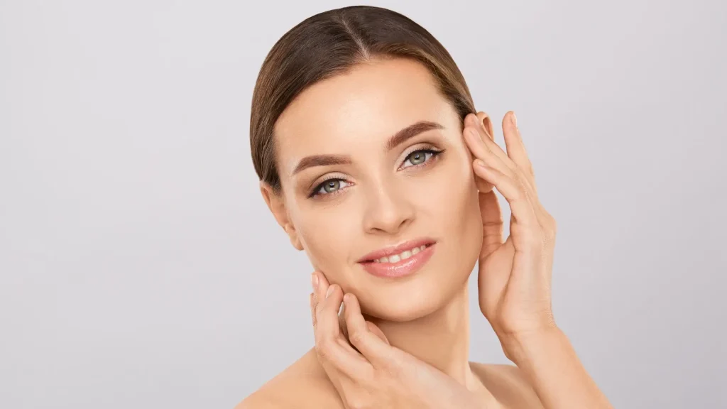 A woman showing off their smooth and clear facial skin.