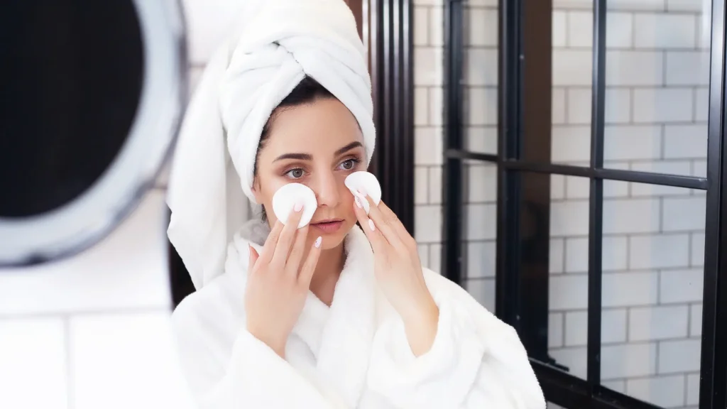 An individual performing their skincare routine.