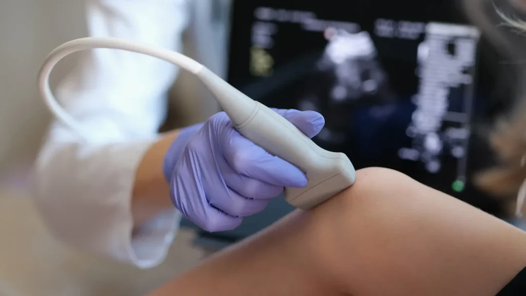 An individual undergoing a knee examination.