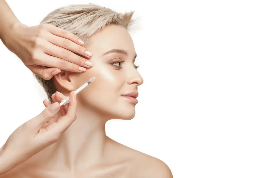 An individual receiving an injection in their mid-face region.