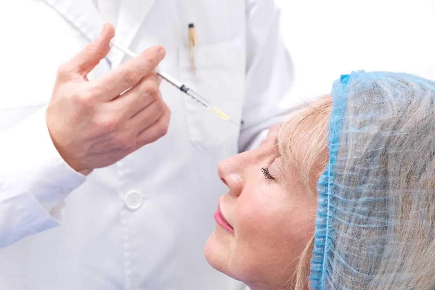 A medical provider administering a facial injection into a patient.