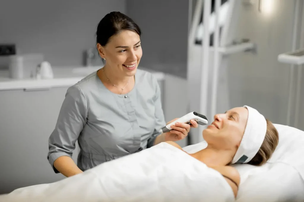 An individual undergoing a facial skin examination with an aesthetic provider.