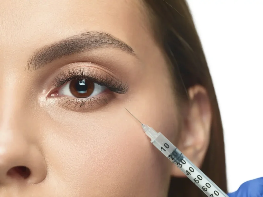 An individual receiving an injection into their under eye region.