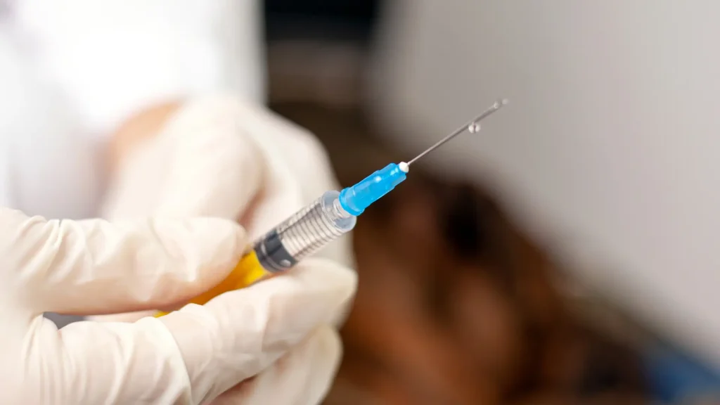 A medical professional preparing the injection.