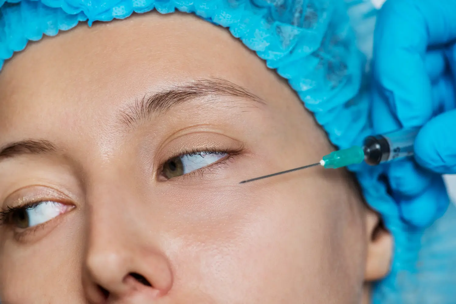 An individual undergoing an injection for their under eye region.