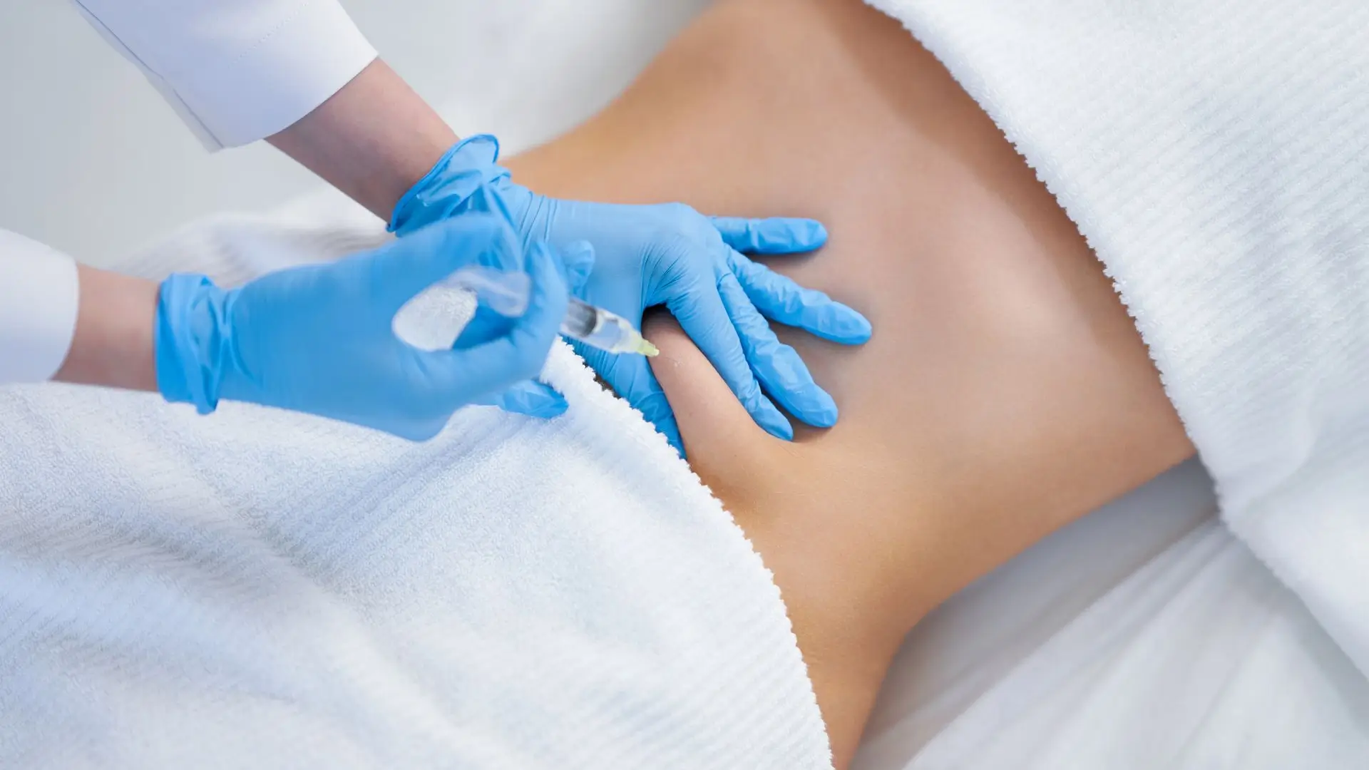 A healthcare professional administering an injection for body sculpting treatment.