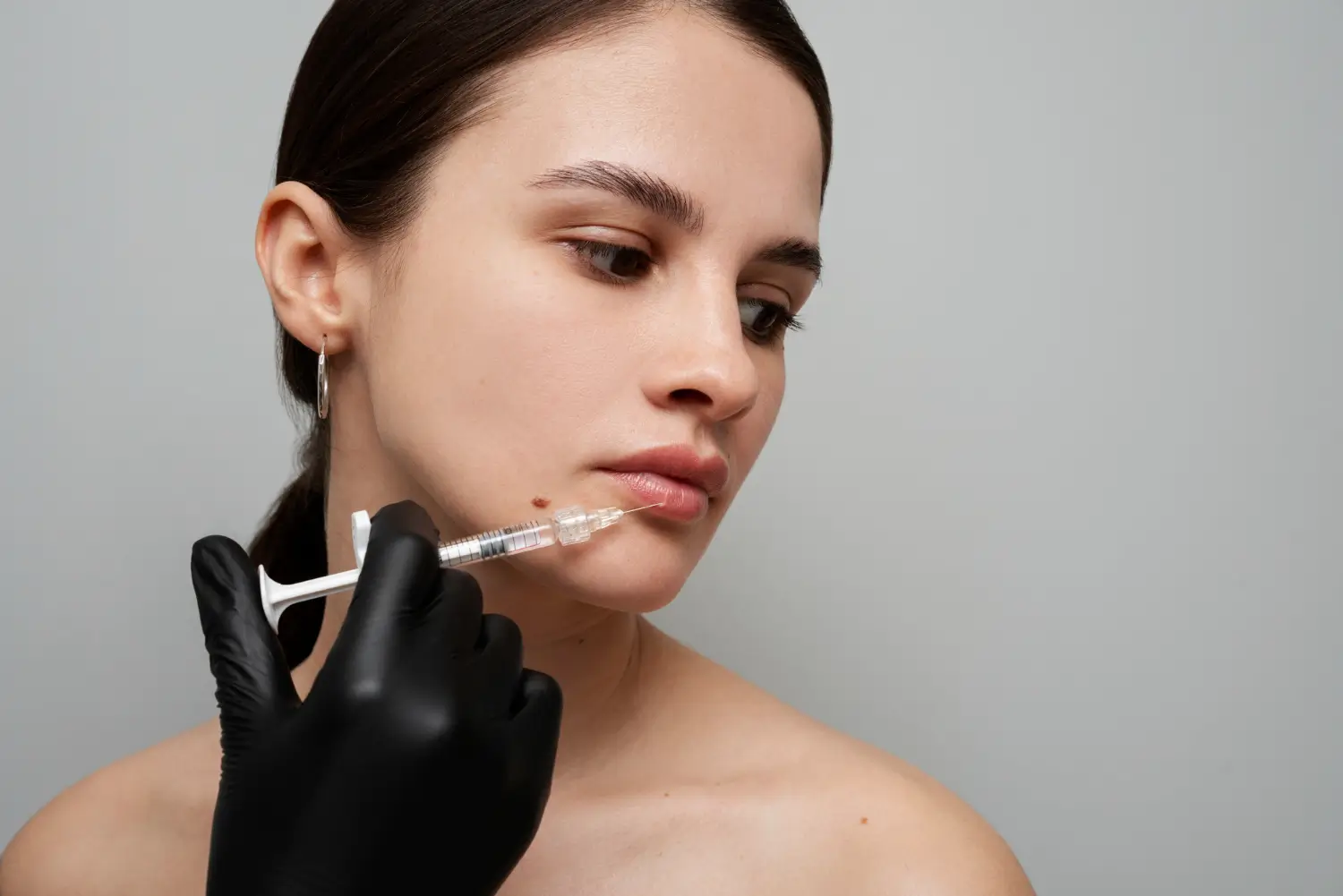 An individual receiving a lip injection filler.