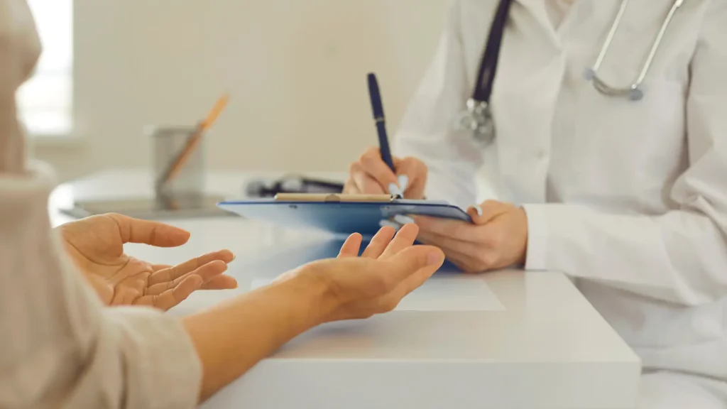 An individual undergoing a consultation with a medical professional.