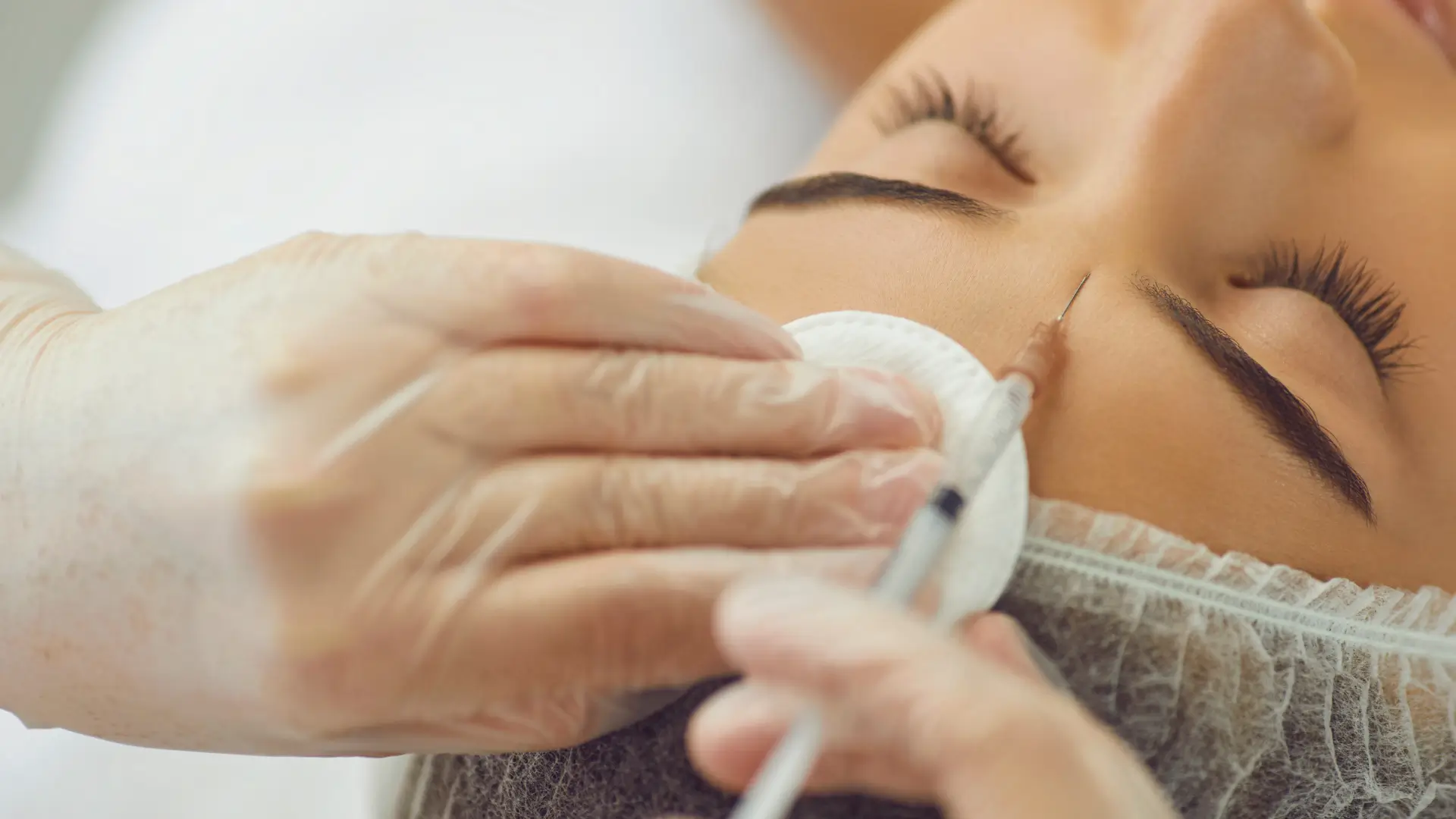An individual receiving an injection for their frown lines.