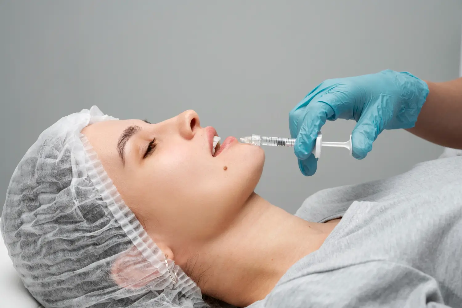 A patient receiving a dermal filler injection for their lips.