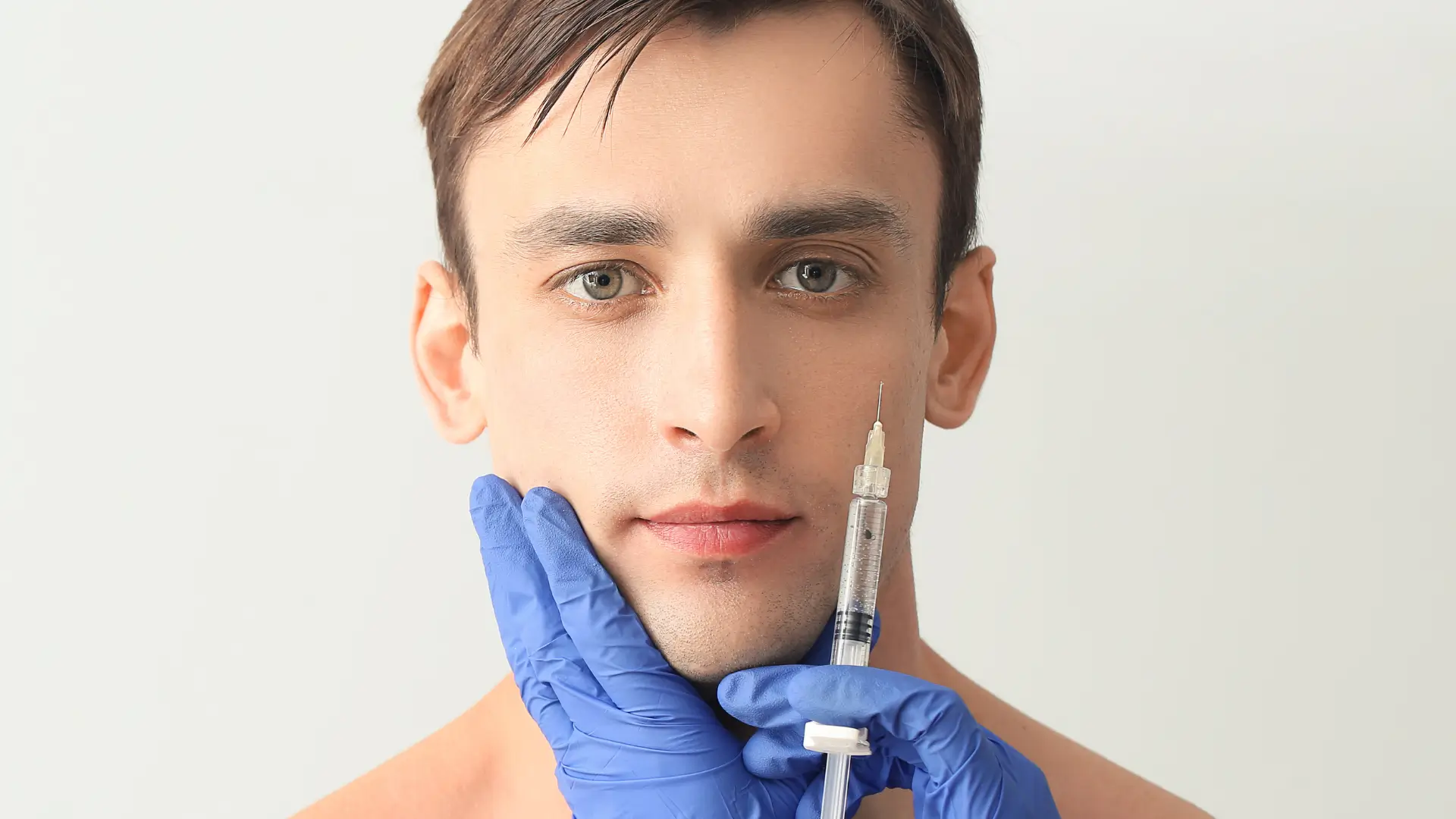 A patient preparing for a facial injection.