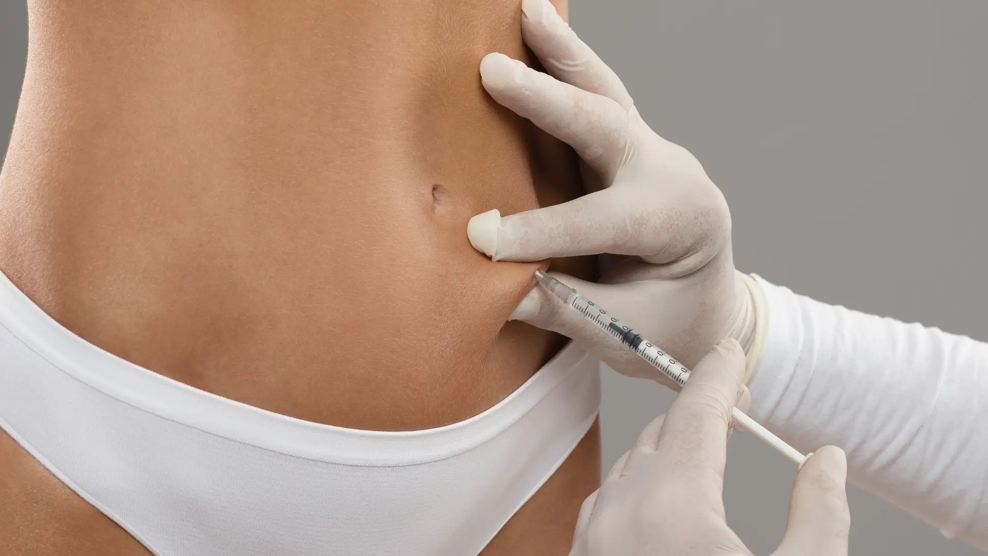 An individual receiving an injection for their abdomen.