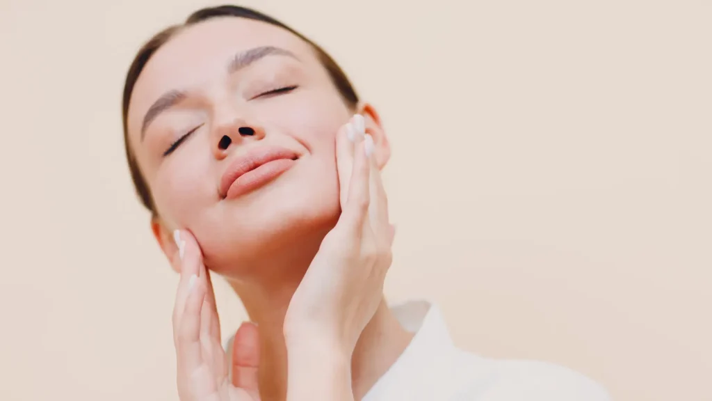 An individual showing off their smooth facial skin.
