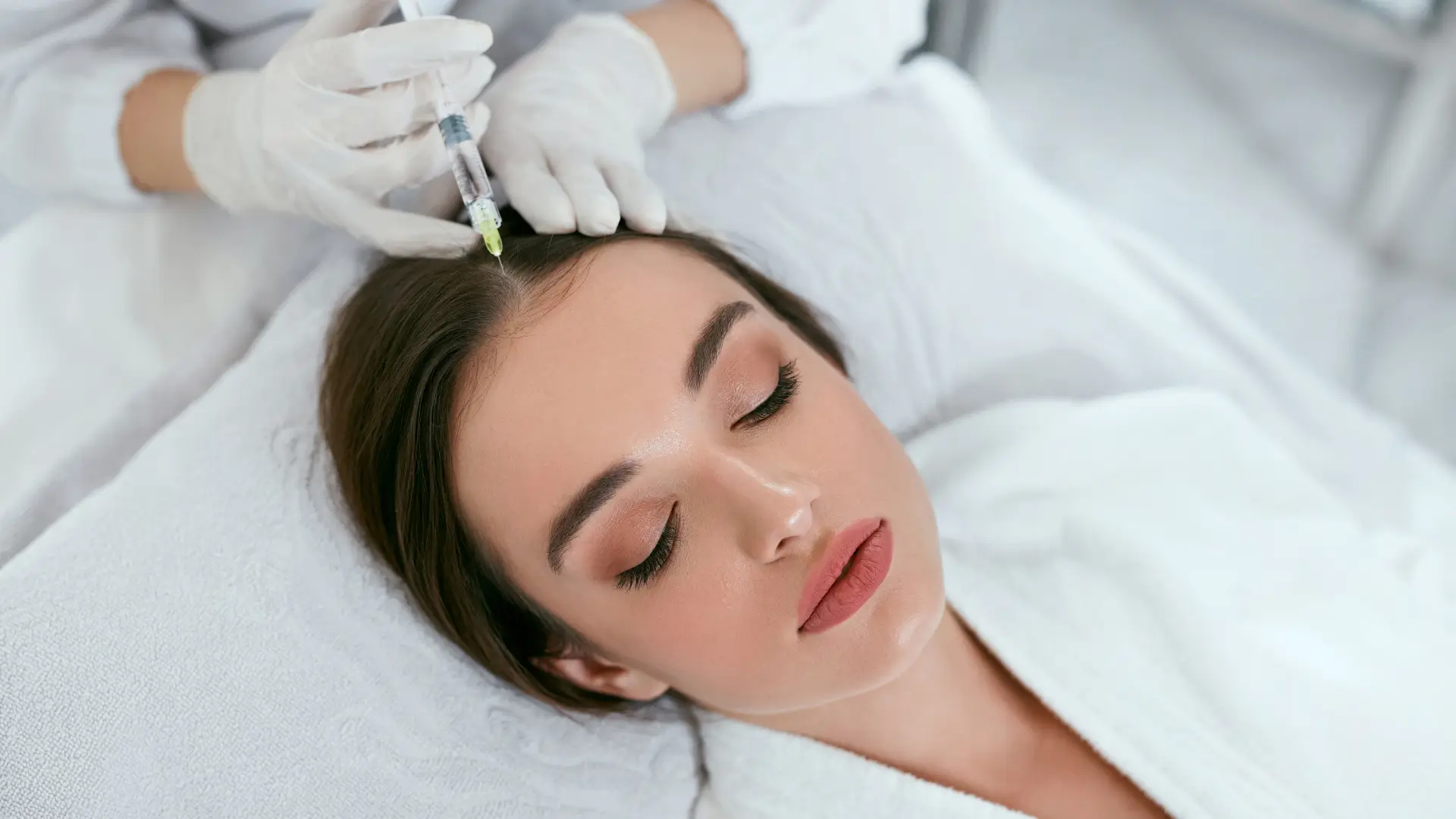 An individual receiving a mesotherapy injection for their hair rejuvenation.