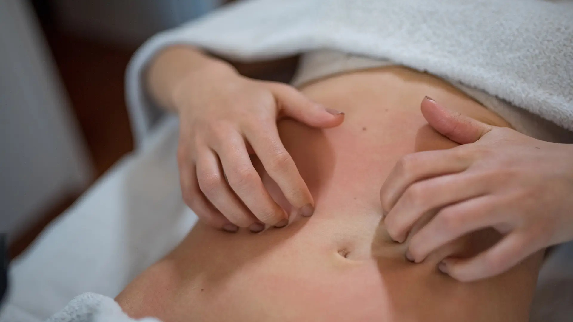 An individual scratching the itchy skin on their abdomen.