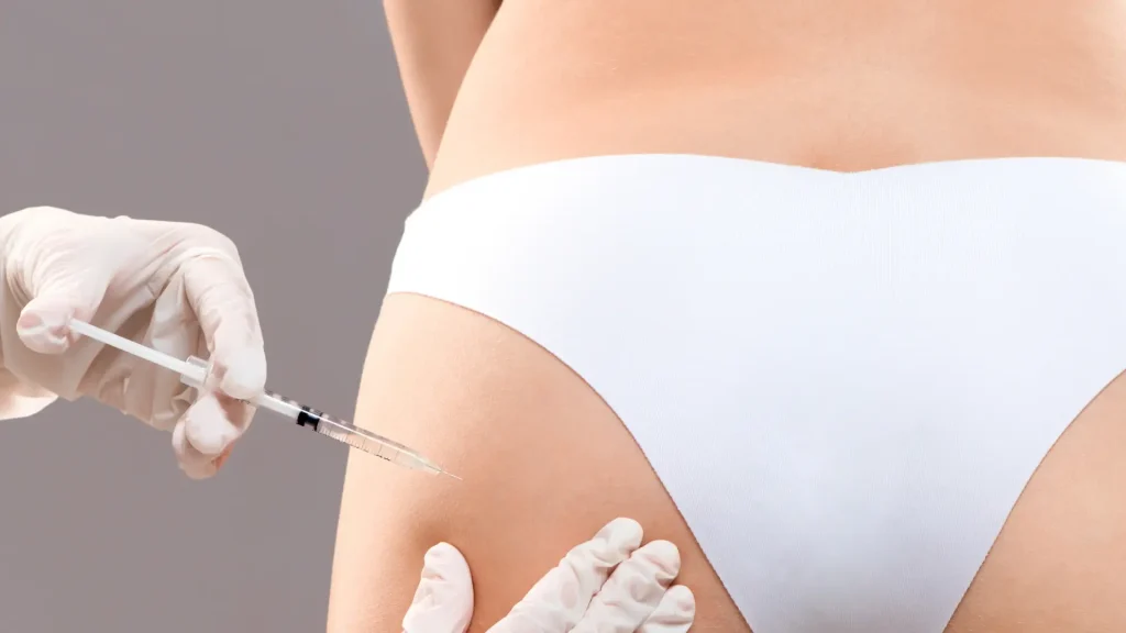 An individual receiving an injection for their cellulite in their buttocks.