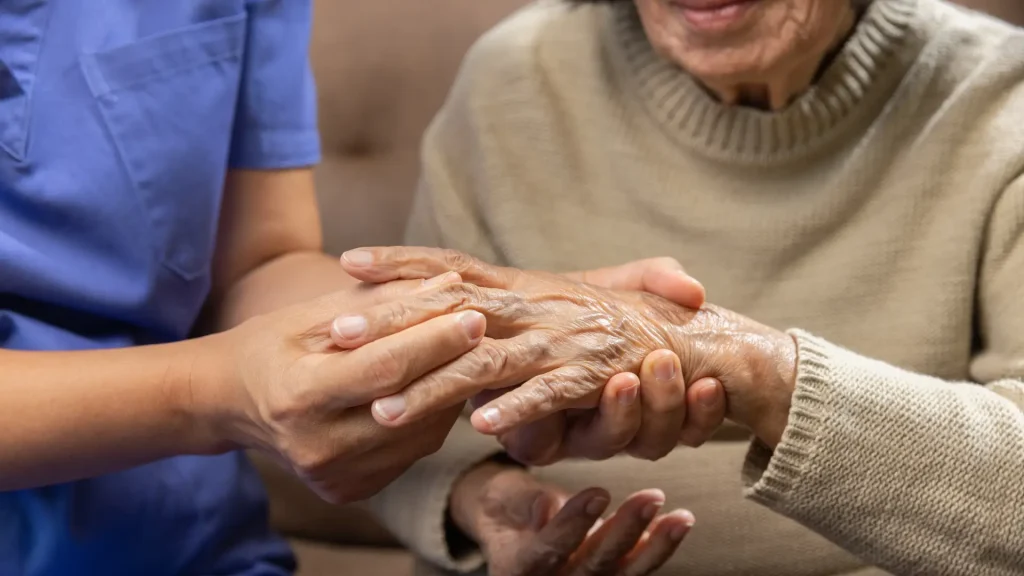 An elderly woman suffering from painful and swollen rheumatoid arthritis.