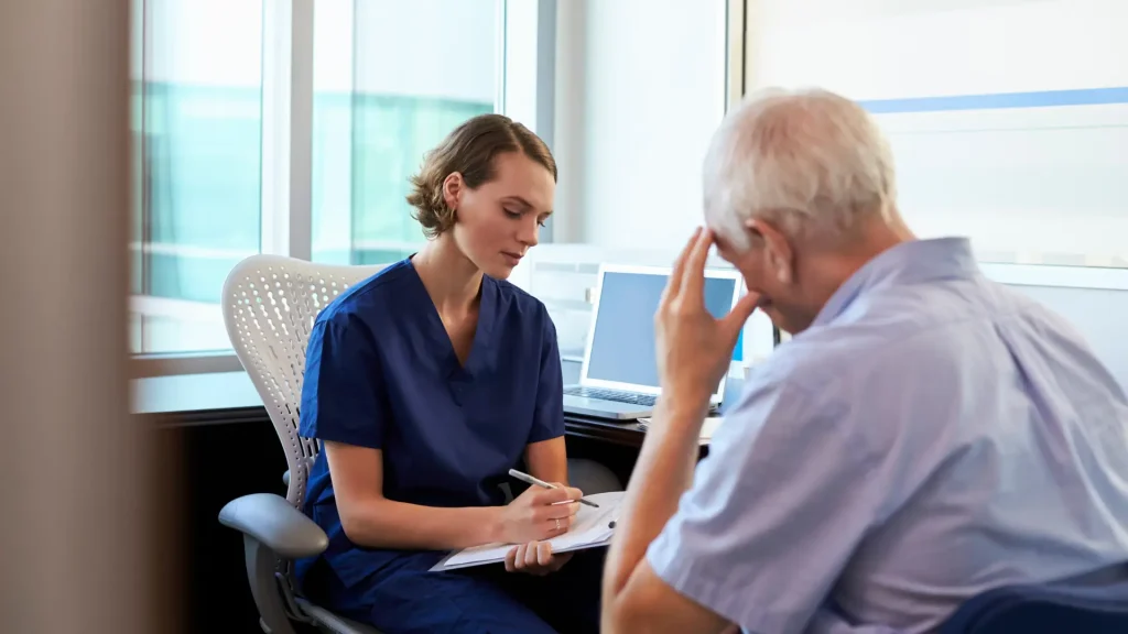 An elderly individual undergoing a consultation with a medical professional.