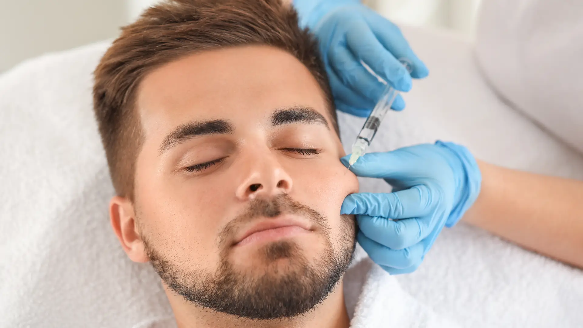 An individual receiving an injection for their cheek region.