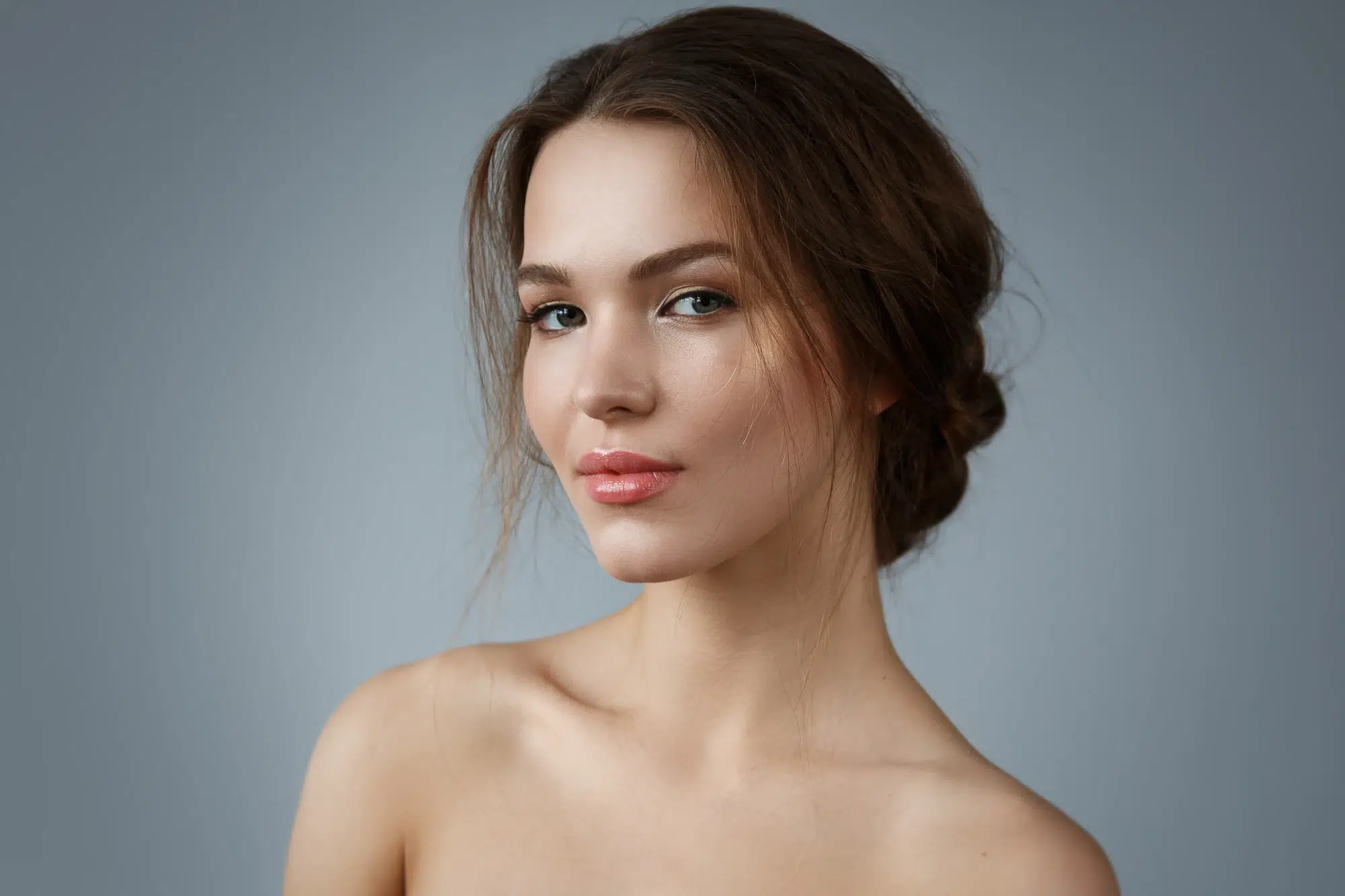 portrait of a woman against grey background