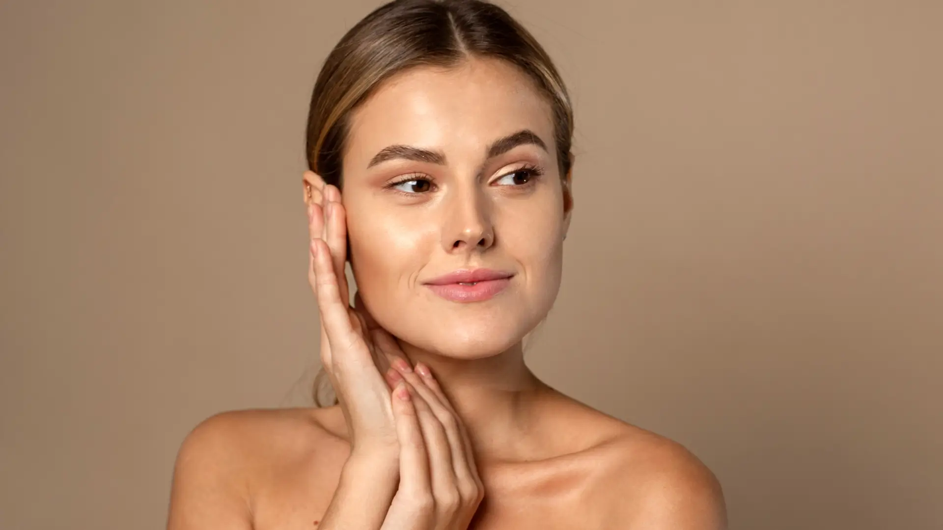 An individual showing off their clear and hydrated skin.