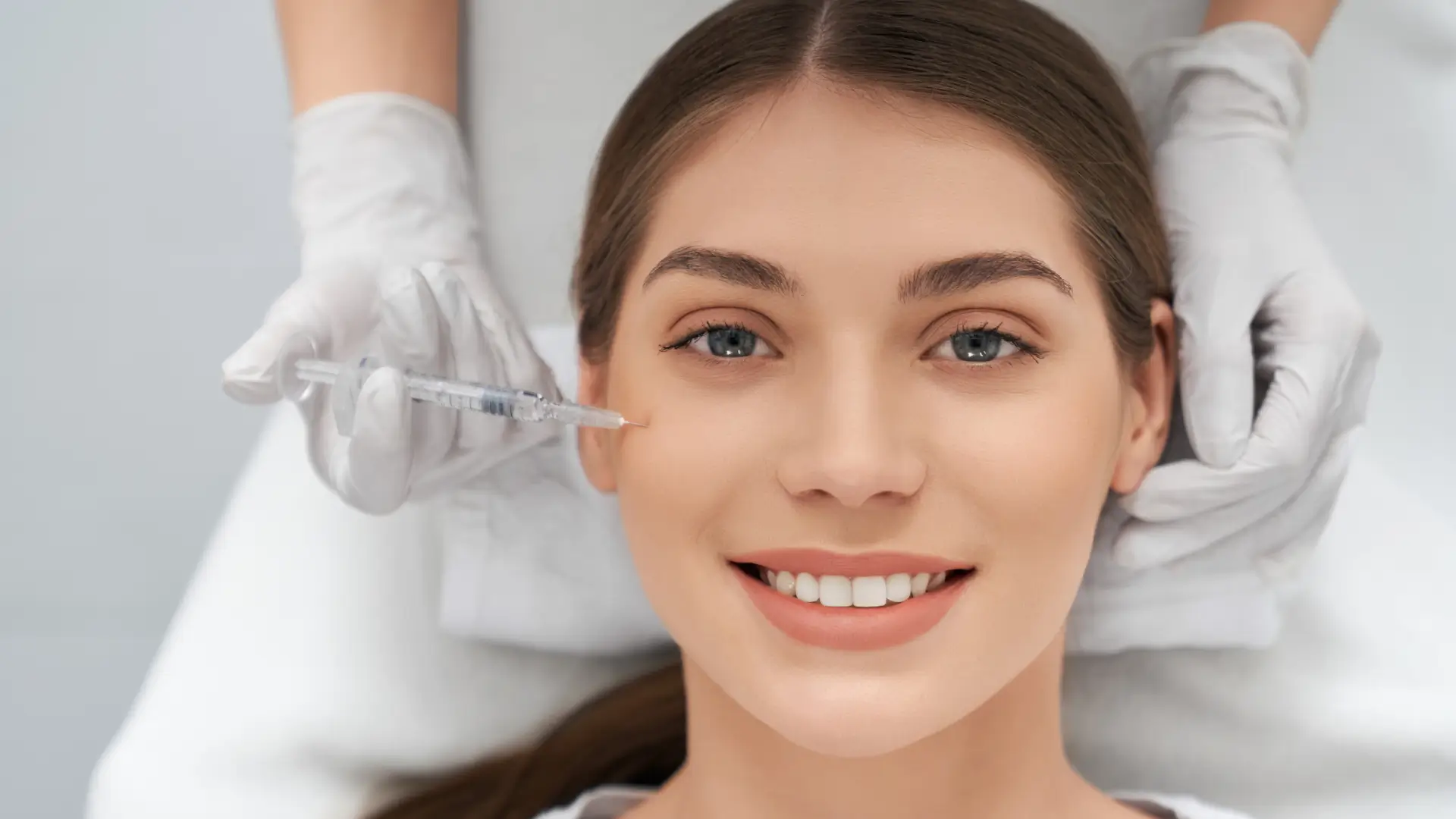 An individual undergoing an injection treatment for their cheeks.