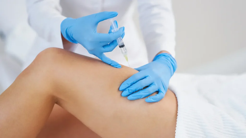 A patient receiving an injection for their thigh region.