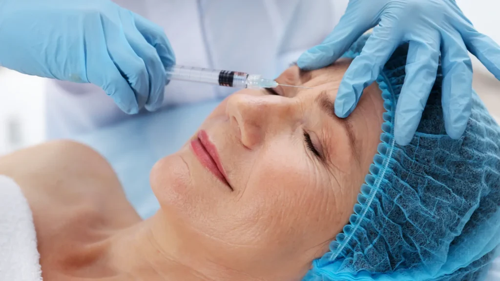 An individual receiving a hyaluronic acid injection for their '11' lines.