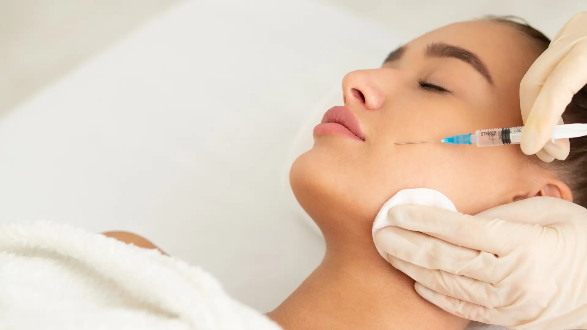 An individual receiving an anti-aging injection from a medical practitioner.