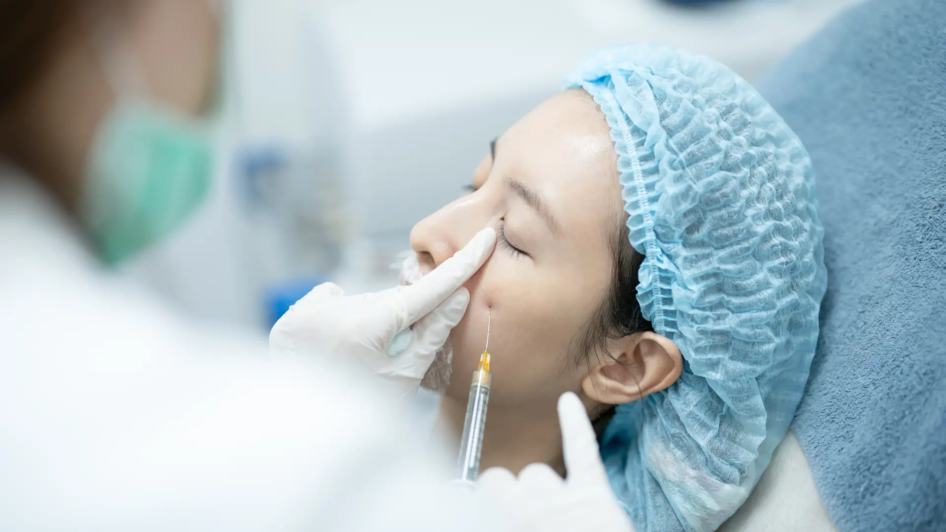 An individual receiving an injection in their under eye region.