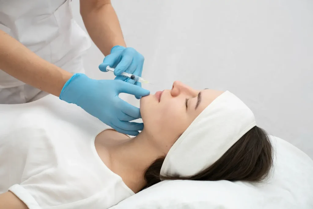 An individual receiving an injection for their lip region.