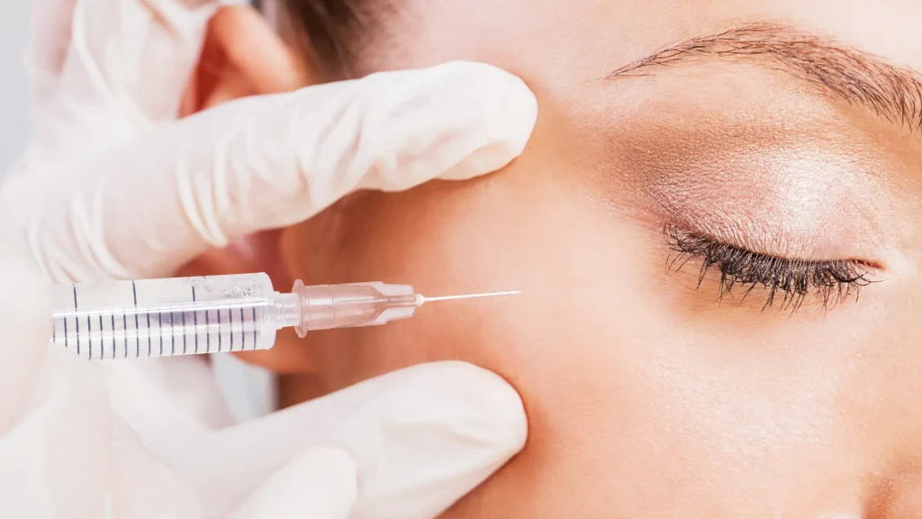 An individual receiving an injection for thier under eye region.