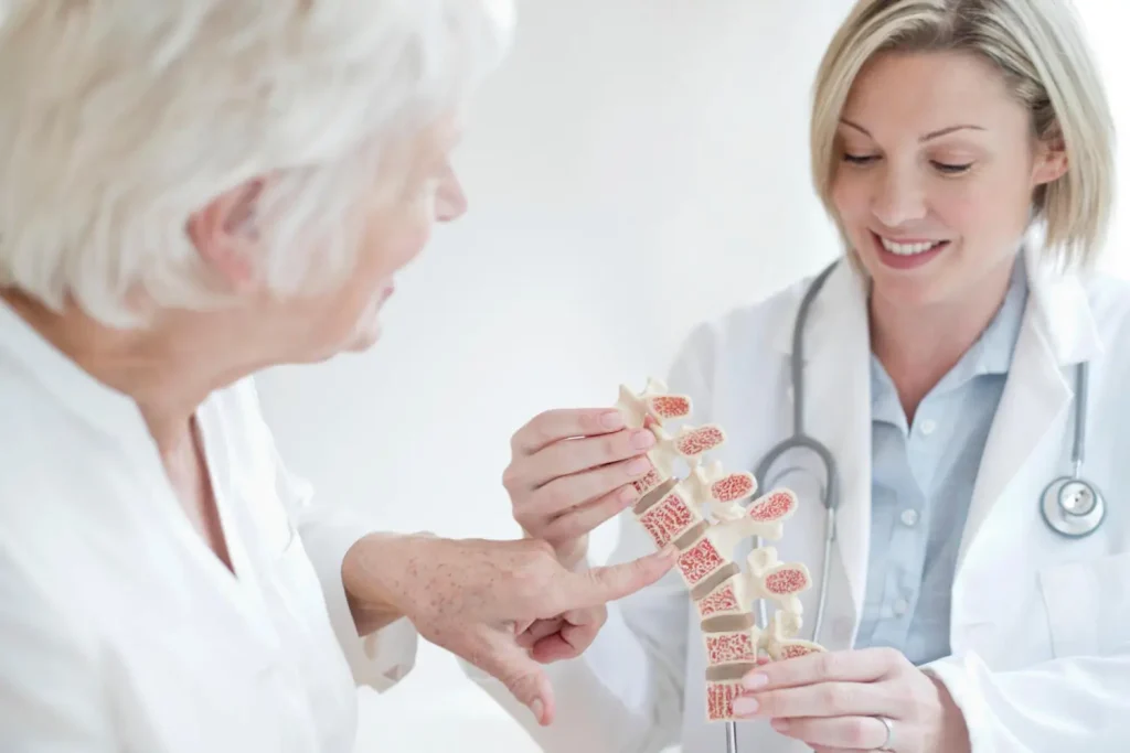 A medical professional discussing the bone concern with an older patient.