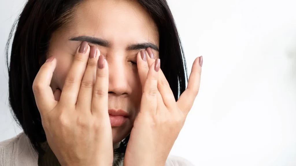 An individual dealing with eye pain or discomfort.