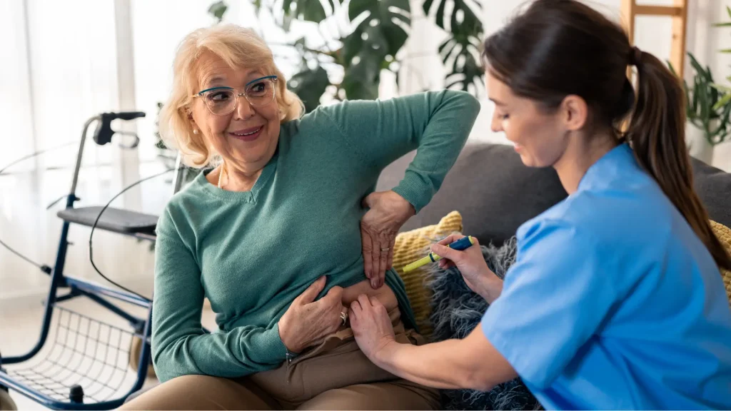 An older individual receiving an injection in their abdomen.