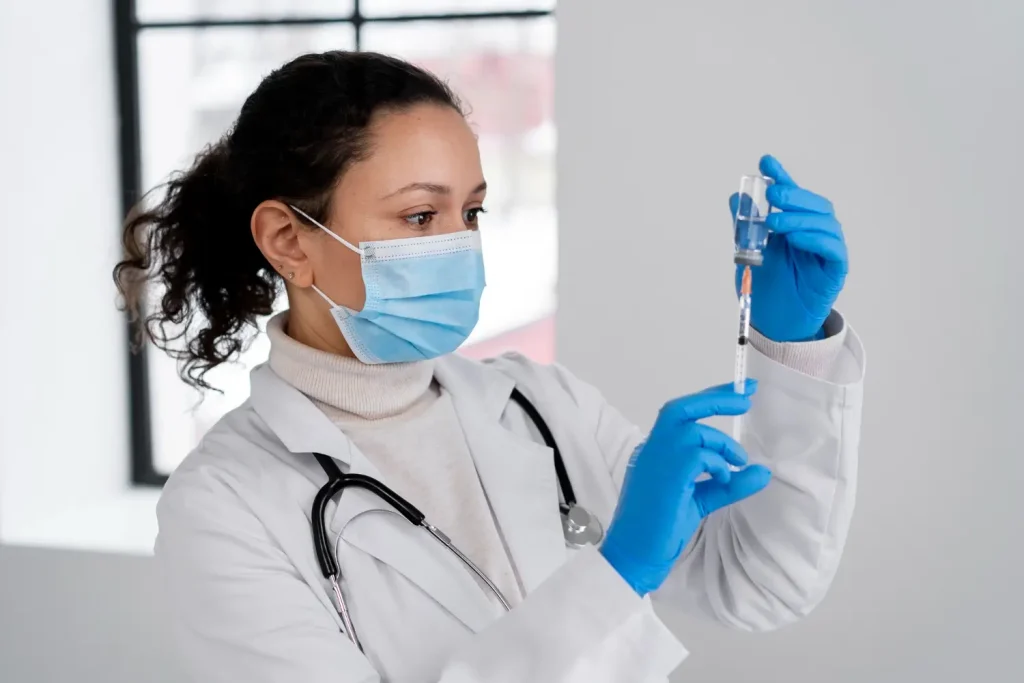 A medical professional preparing an injection.
