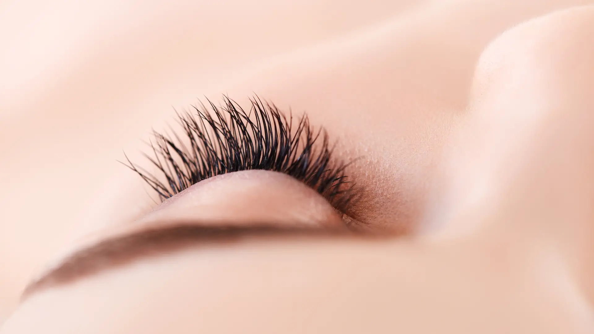 A close-up shot of an individual's long, thick eyelashes.