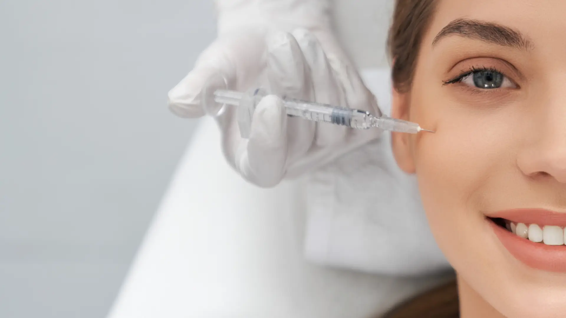 An individual receiving an injection for their facial region.