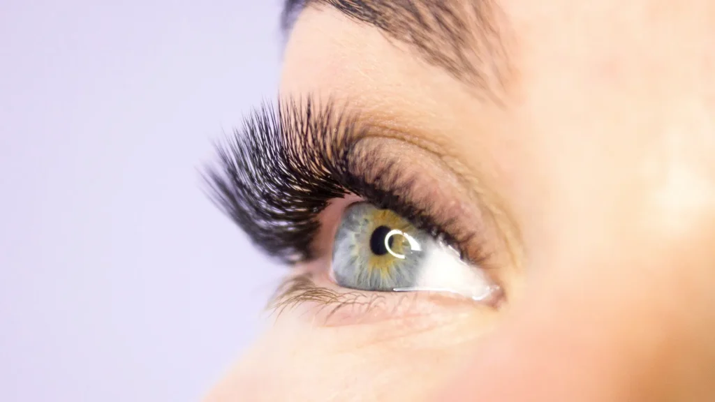 A close-up shot of a woman's long, thick eyelashes.