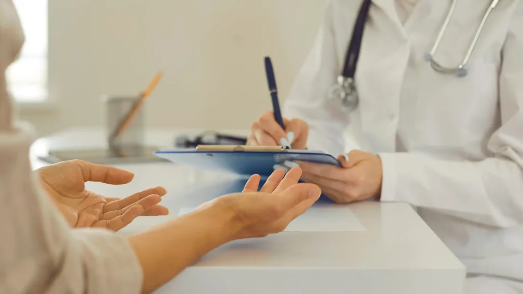 A medical professional and patient consultation.